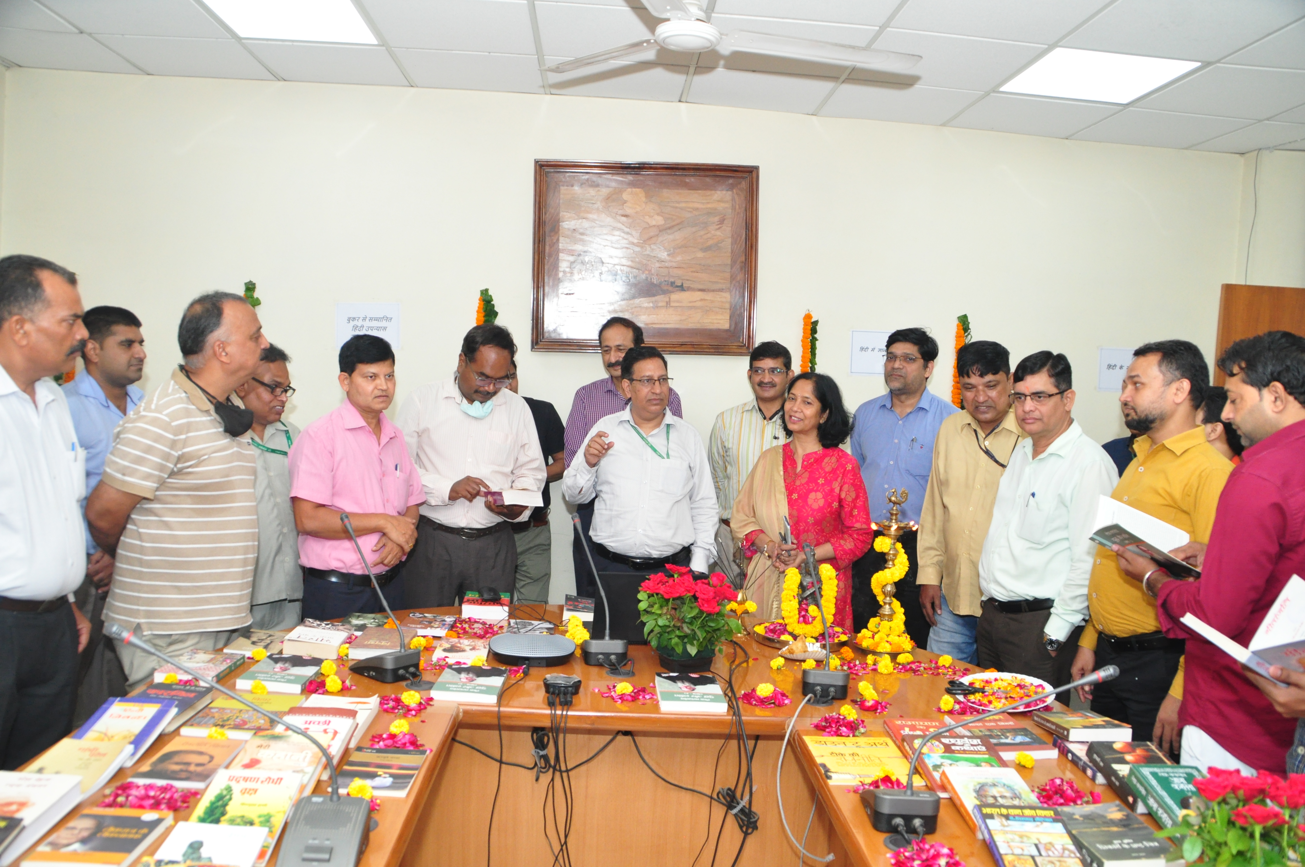 Officers and officials of the office inspecting the books in the Hindi book exhibition